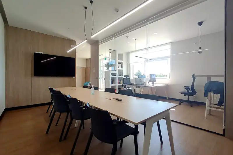 fully equipped meeting room in Lavra coworking space with glass partition and modern furnishings